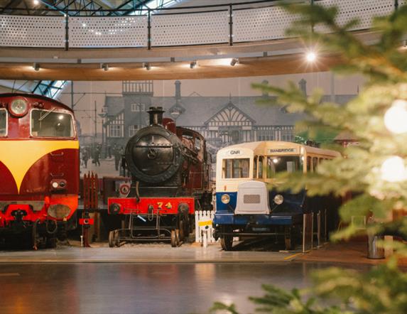 A photo of two trains in the Ulster Transport Museum Rail Galllery decorated for Christmas