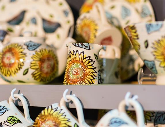 Photo of professionally painted ceramic pieces or sale with a sunflower pattern