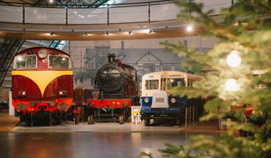 A photo of two trains in the Ulster Transport Museum Rail Galllery decorated for Christmas