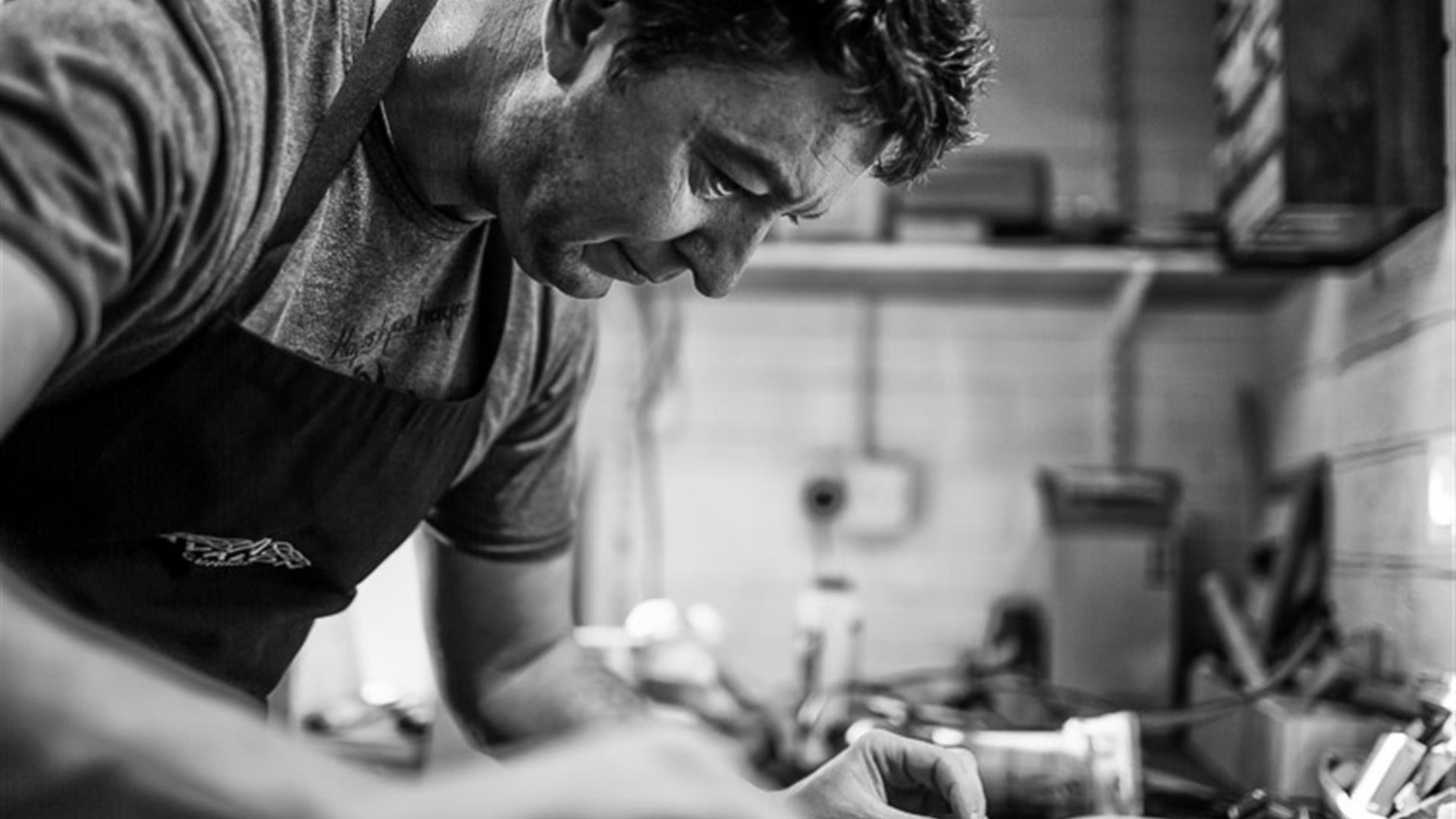 Photo showing a craftsman building a guitar from scratch