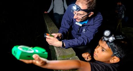 A child with a Bat expert listening out for bats