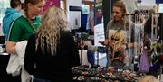 Attendees at HappyFest browsing the stalls in the Exhibition Halls