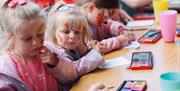 Children with Face Paint taking part in Art Therapy at HappyFest