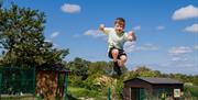 Photo of Jumping pillow at The Ark Open Farm with a little boy bouncing