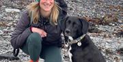 Aileen and her dog on beach