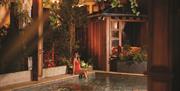 A woman sitting on the edge of the spa pool