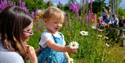 Mother and child looking at flowers.