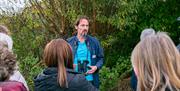 A group of visitors listening to a member of WWT staff.