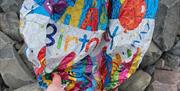 deflated birthday balloon on beach