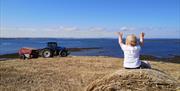 Child waving at Tractor Strangford Lough